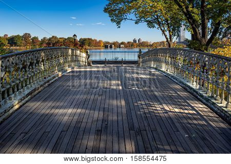 Bridge No. 27 in Central Park with view on the Jacqueline Kennedy Onassis Reservoir in Fall. Upper West Side, Manhattan, New York City