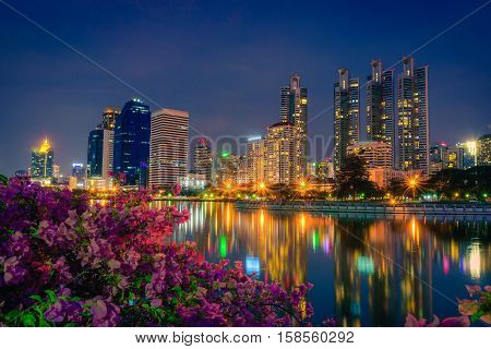 Cityscape image of Benchakitti Park at night sky in Bangkok Thailand.