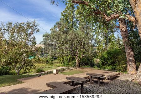Lisbon, Portugal - October 19, 2016: Tables and benches in the garden of the Calouste Gulbenkian foundation. A very popular urban park open to the public especially among College students.