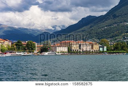 Lugano, Switzerland - August 25, 2013: Ships at the promenade of the luxurious resort in Lugano on Lake Lugano and Alps mountains in Ticino canton Switzerland.