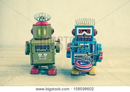 Old robot toy on wood table, vintage color style, vintage tone background.