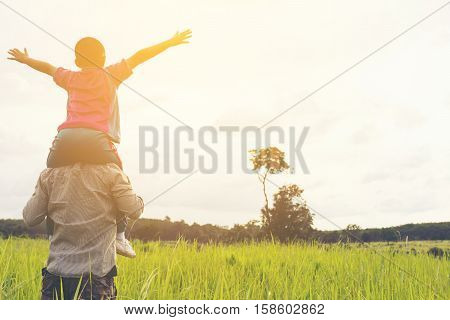 Family with mountain view,Or Father and son are happy with travel and picnic with mountain and sunshine view.1