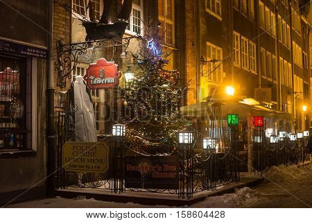 POLAND GDANSK - DECEMBER 30 2014: Night street of Gdansk in festive decoration before Christmas. Gdansk is a Polish city on the Baltic coast and popular center of tourism.