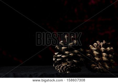 New Year Two Pine Cone On A Dark Red Background