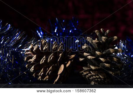 Christmas Pines And Tinsel On A Dark Red Background