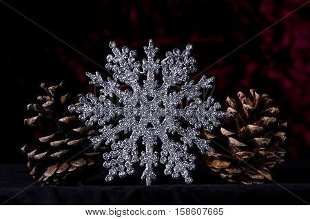 New Year Two Pine Cone And Christmas Star On A Dark Red Background