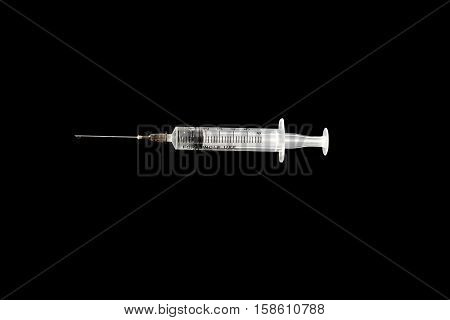 New Syringe and needle on black background.