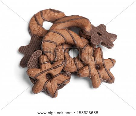 Heap of chocolate cookies in different shape isolated on white background
