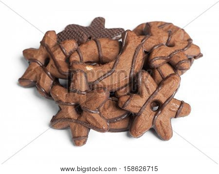 Heap of chocolate cookies in different shape isolated on white background