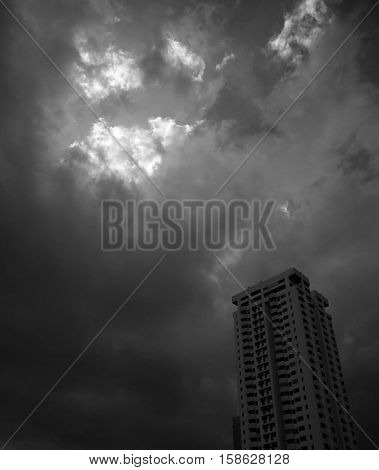 A BUILDING WITH DARK STORMY SKY IN THE BACKGROUND