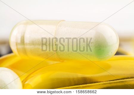 Natural food supplement pills glucosamine and omega 3 capsules macro image