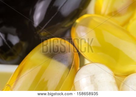Mixed natural food supplement pills omega 3 glucosamine vitamin e vitamin a capsules macro image