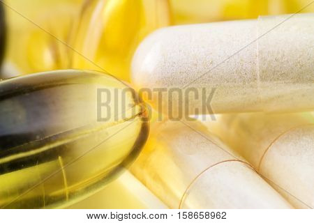 Mixed natural food supplement pills omega 3 glucosamine vitamin e capsules macro image