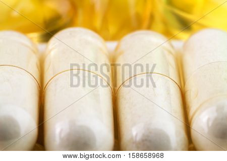 Natural food supplement pills glucosamine and omega 3 capsules macro image