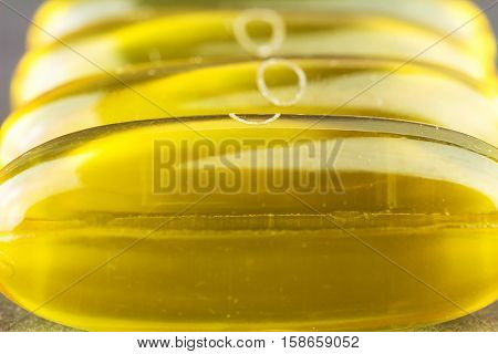 Natural food supplement yellow gel pill fatty acid omega 3 capsules fish oil macro image