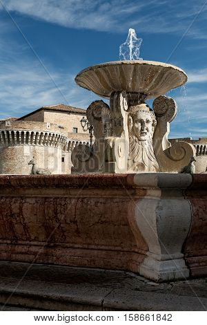 The ancient fountain in front of medieval fortress in Senigallia