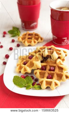 Dessert waffles with cranberries and chocolate syrup