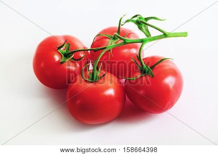 Ripe tasty fresh red tomatoes with a branch. Selective focus.