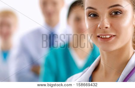 Group of doctors at hospital, focused at female physician.
