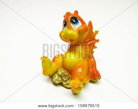 small statuette of small dragon isolated background