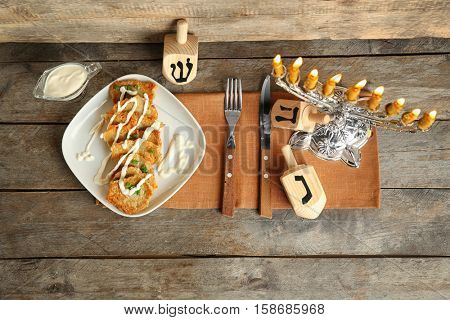 Beautiful composition for Hanukkah on wooden table