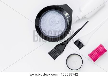 Tools for hair dye and hairdye top view on white background