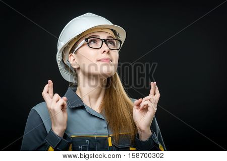 portrait of a young female worker on the black background