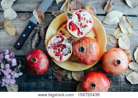 Ripe Pomegranate Fruit On Wooden Vintage Background. Red Juice P