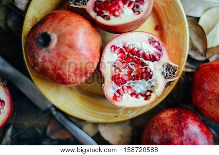 Ripe Pomegranate Fruit On Wooden Vintage Background. Red Juice P
