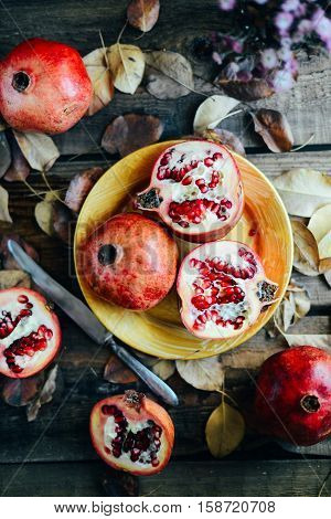 Ripe Pomegranate Fruit On Wooden Vintage Background. Red Juice P