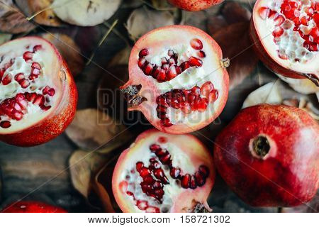 Ripe Pomegranate Fruit On Wooden Vintage Background. Red Juice P