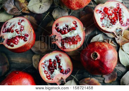 Ripe Pomegranate Fruit On Wooden Vintage Background. Red Juice P