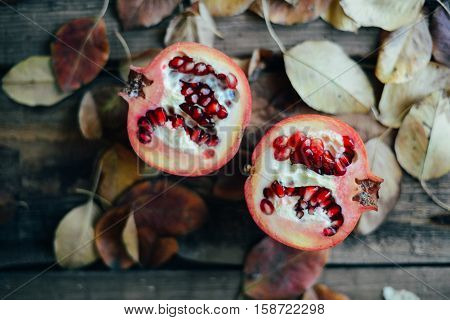 Ripe Pomegranate Fruit On Wooden Vintage Background. Red Juice P