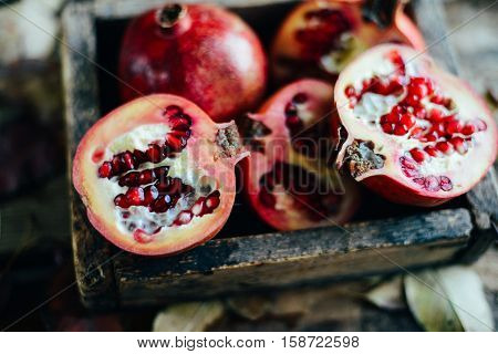 Ripe Pomegranate Fruit On Wooden Vintage Background. Red Juice P