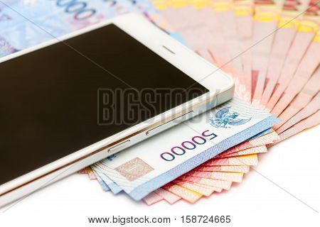 Smartphone And Money Of Indonesian Rupiah