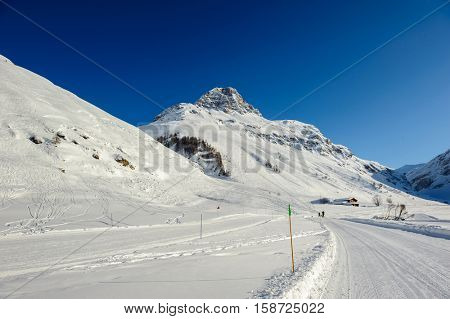 Alpine winter mountain landscape. French Alps covered with snow in sunny day. Val-d'Isere, France