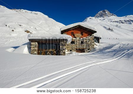 Alpine winter mountain landscape. French Alps covered with snow in sunny day. Val-d'Isere, France
