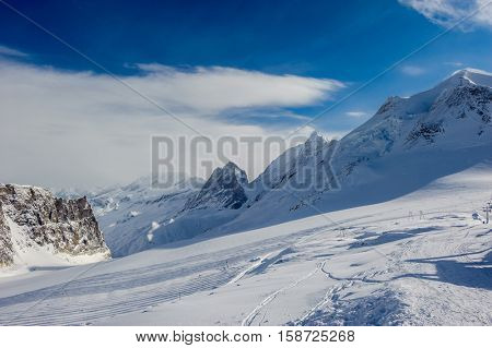 Alpine winter mountain landscape. French Alps covered with snow in sunny day. Val-d'Isere, France