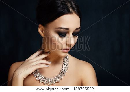 people luxury jewelry and fashion concept - Fashion portrait of young beautiful lady with earring on black background