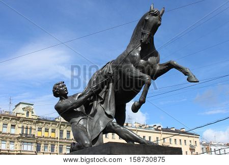 Horse Tamers statue in the Anichkov bridge of St. Petersburg, Russia