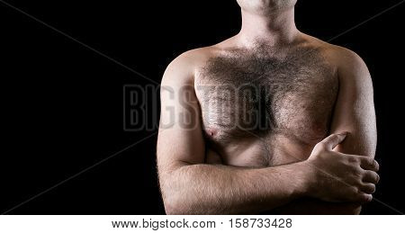 Man with hairy chest isolated on black background.
