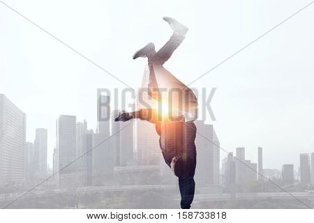 B-boy performing some moves . Mixed media