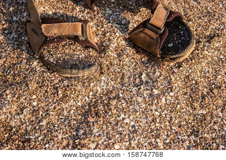 Sandals and sand. Shoes under sunlight. Get lost on tropical island. Escape to the ocean.