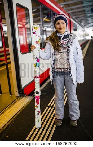 Young ski girl on train Station in Zermatt.