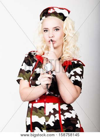 young beautiful woman dressed as a miliyary nurse, medical carnival costume.