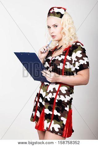 young beautiful woman dressed as a miliyary nurse, medical carnival costume.