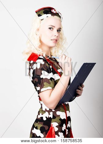 young beautiful woman dressed as a miliyary nurse, medical carnival costume.