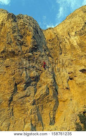 Rock climber on a steep rock. Cape Alchak Crimea.