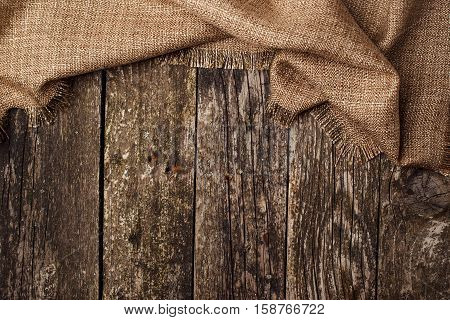 Dark ooden backgrond with piece of cloth.
