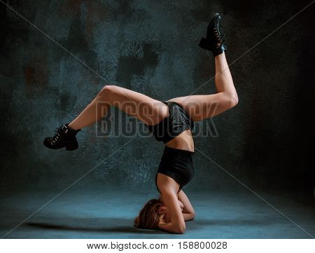 Attractive girl dancing twerk iat the blue studio background